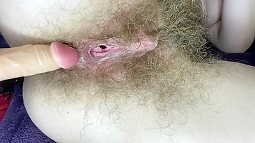 Blonde whore sticks dildo into her impossibly-hairy cunt till orgasm