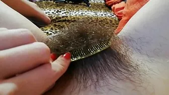 Naked babe brushes her hairy bush in front of the amateur camera Naked babe brushes her hairy bush in front of the amateur camera