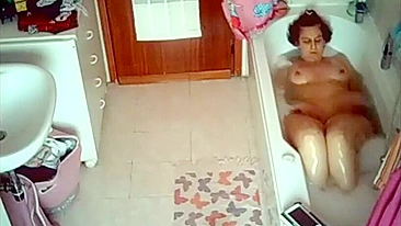 Curvy wife caught masturbating and reading while taking a bubble bath