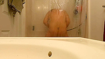 Wife stimulates cunt with water being caught masturbating in shower