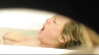 Mom is caught masturbating by son who films through the small hole