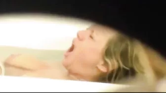 Mom is caught masturbating by son who films through the small hole