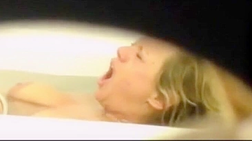 Mom is caught masturbating by son who films through the small hole