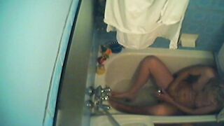 Sister is caught masturbating with water stream in the small bathtub