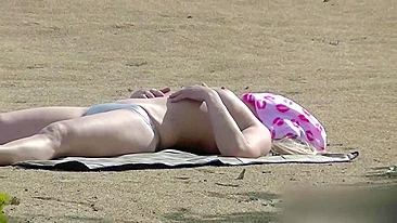 I peeping a tanning and masturbating blonde babe