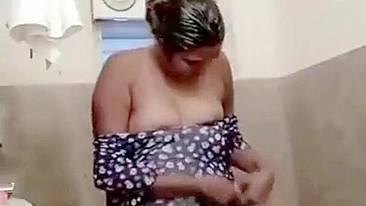 A plump indian aunty getting dressed after bath