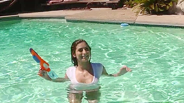 Chick fools around in pool with water gun and naked XXX body parts