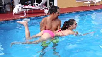 Minx in pink XXX bikini learns to swim together with Latin trainer