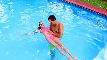 Minx in pink XXX bikini learns to swim together with Latin trainer