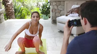 Fitness blogger stretches in hot XXX poses in front of her cameraman
