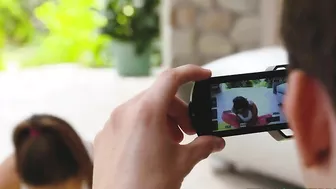 Fitness blogger stretches in hot XXX poses in front of her cameraman