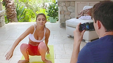 Fitness blogger stretches in hot XXX poses in front of her cameraman