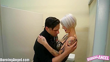 Tattooed girl with short blonde hair rides cock in toilet stall