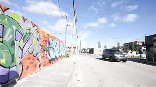 Mom walks by graffiti wall and brandishes her XXX assets on camera