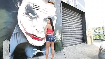 Mom walks by graffiti wall and brandishes her XXX assets on camera