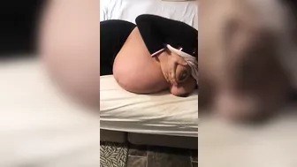 Pregnant Iraqi mom lies on the bed and teases with her XXX breasts