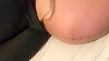Pregnant Iraqi mom lies on the bed and teases with her XXX breasts