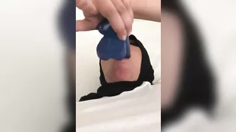 Blue XXX toy is inside mouth of Dubai mom in white top and colorful pants