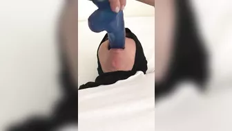 Blue XXX toy is inside mouth of Dubai mom in white top and colorful pants
