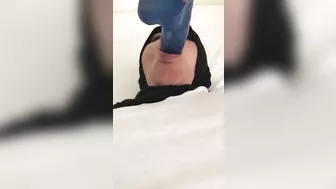 Blue XXX toy is inside mouth of Dubai mom in white top and colorful pants