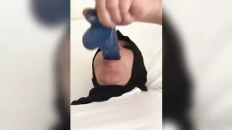 Blue XXX toy is inside mouth of Dubai mom in white top and colorful pants