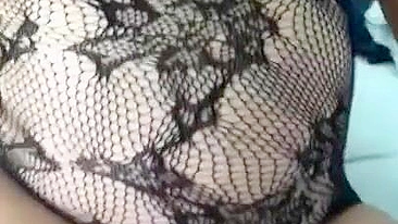 Pervert Arab mom in fishnet nightgown touches her XXX sized boobies