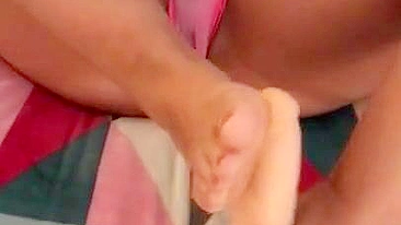 Super-hot Arab mom in pink panties gives a XXX footjob to a big sex toy