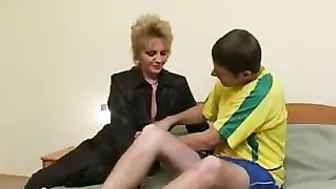 Football player relaxes on bed together with mom in XXX stockings