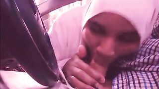 Lecherous Arab mom in white hijab sucks her man's cock in the car