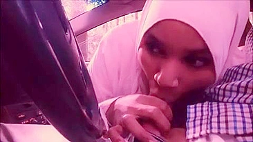 Lecherous Arab mom in white hijab sucks her man's cock in the car