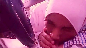 Lecherous Arab mom in white hijab sucks her man's cock in the car