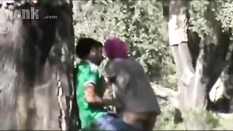 Dressed Arab mom bends by the tree to get fucked hard in the woods