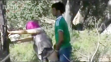 Dressed Arab mom bends by the tree to get fucked hard in the woods