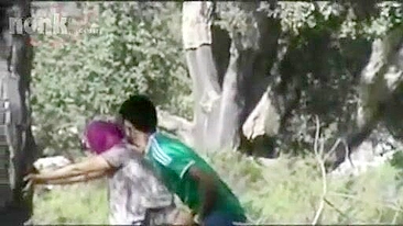 Dressed Arab mom bends by the tree to get fucked hard in the woods