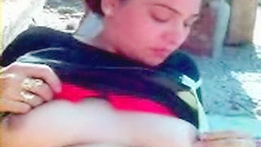 Sweet Arab mom exposes her big breasts and shaved cunt outdoors