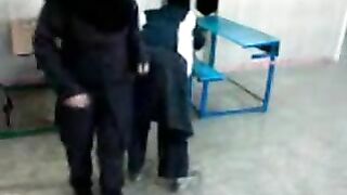 Several Arab girls in hijab play naughty games in the classroom