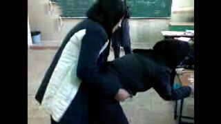 Several Arab girls in hijab play naughty games in the classroom