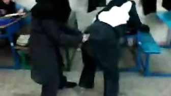 Several Arab girls in hijab play naughty games in the classroom