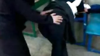 Several Arab girls in hijab play naughty games in the classroom