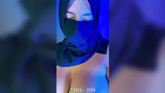 Muslim mistress wife in hijab putting a condom on big strapon