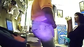 Watch as this seductive brunette employee pleasures her boss's dick for extra cash, unaware of his hidden camera.