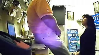 Watch as this seductive brunette employee pleasures her boss's dick for extra cash, unaware of his hidden camera.