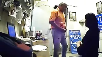 Watch as this seductive brunette employee pleasures her boss's dick for extra cash, unaware of his hidden camera.