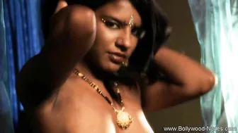 Young Indian model demonstrates perfect body and plays with a snake