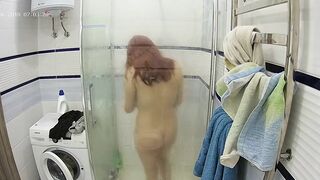 A redheaded caught sister gets in the shower and makes her figure all wet