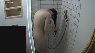 The caught sister continues having her shower unaware of the hidden camera