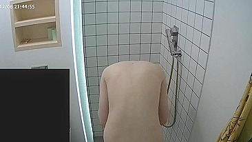 The caught sister continues having her shower unaware of the hidden camera