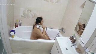 Curvy caught sister is getting wet in the bathtub while being caught on camera