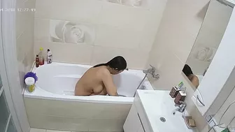Curvy caught sister is getting wet in the bathtub while being caught on camera
