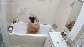 Curvy caught sister is getting wet in the bathtub while being caught on camera